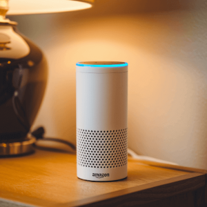 An Amazon Echo device with a blue ring around the top